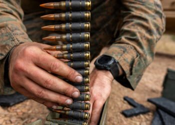 A U.S. Marine with Weapons Company, 1st Battalion, 5th Marine Regiment, Marine Rotational Force – Darwin 26, prepares 7.62 mm ammunition before a reaction-to-contact live-fire range