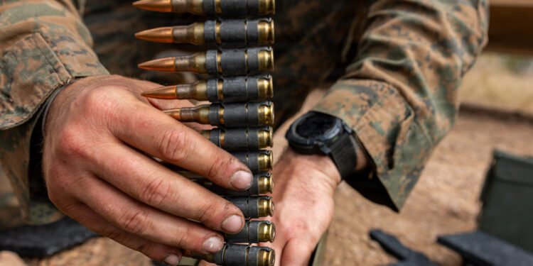 A U.S. Marine with Weapons Company, 1st Battalion, 5th Marine Regiment, Marine Rotational Force – Darwin 26, prepares 7.62 mm ammunition before a reaction-to-contact live-fire range